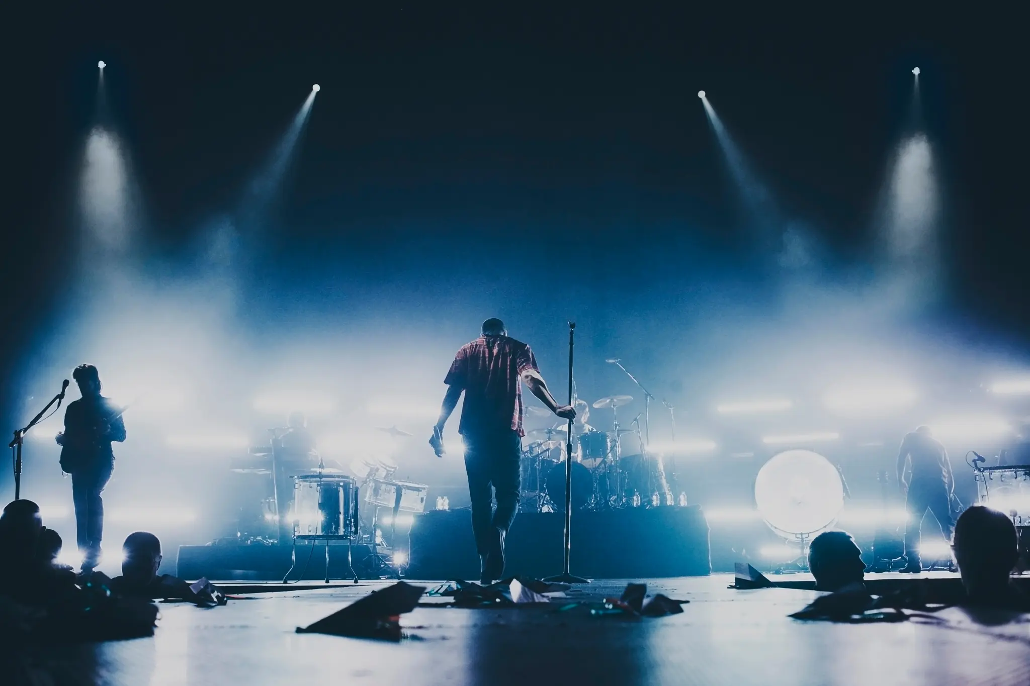 Band performing live on stage under dramatic lighting
